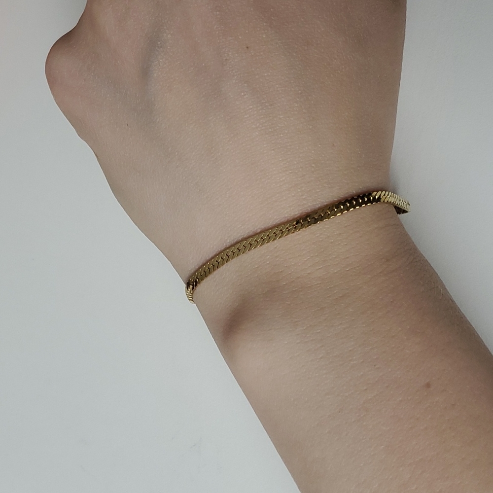 Gold tone herringbone chain bracelet